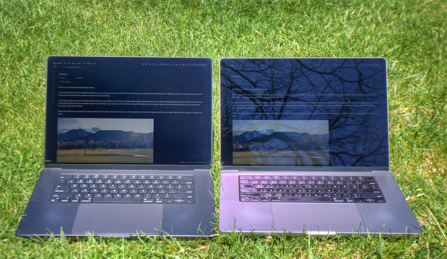2 MacBook Pros sit on the grass. The screen on the right is reflecting far more than the screen on the left.