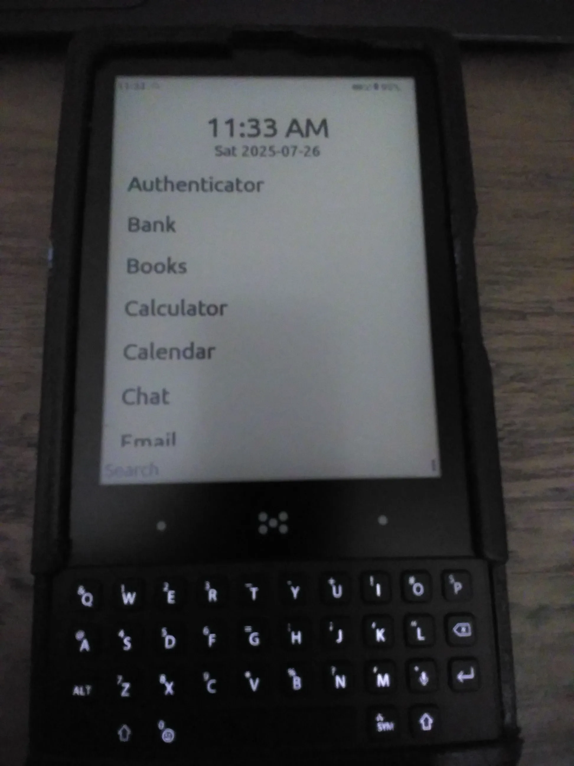 Minimal Phone displaying the home screen and in a slightly crappy 3D printed case.